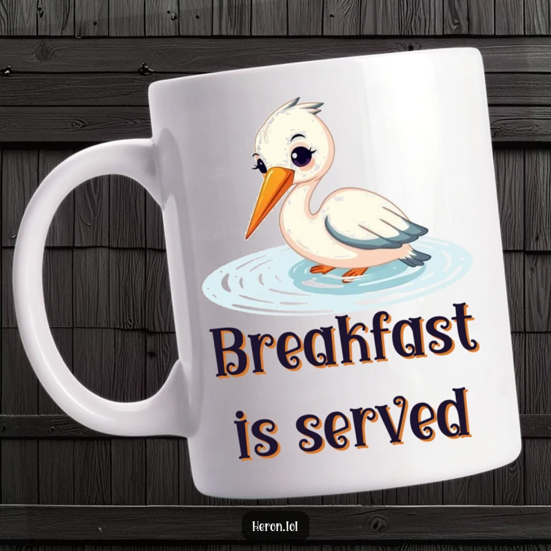 Funny mug showing a smiling heron gracefully fishing, its beak submerged in shimmering water, capturing a serene and happy moment.