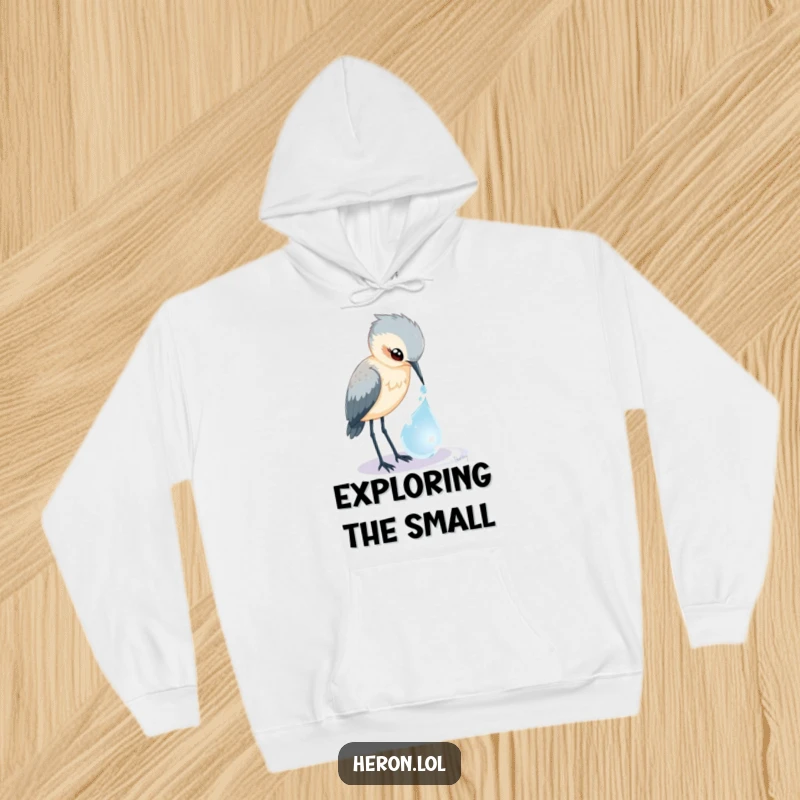 Funny Heron Hoodie: A curious bird peers into a magical dewdrop, offering warmth and humorous enchantment.