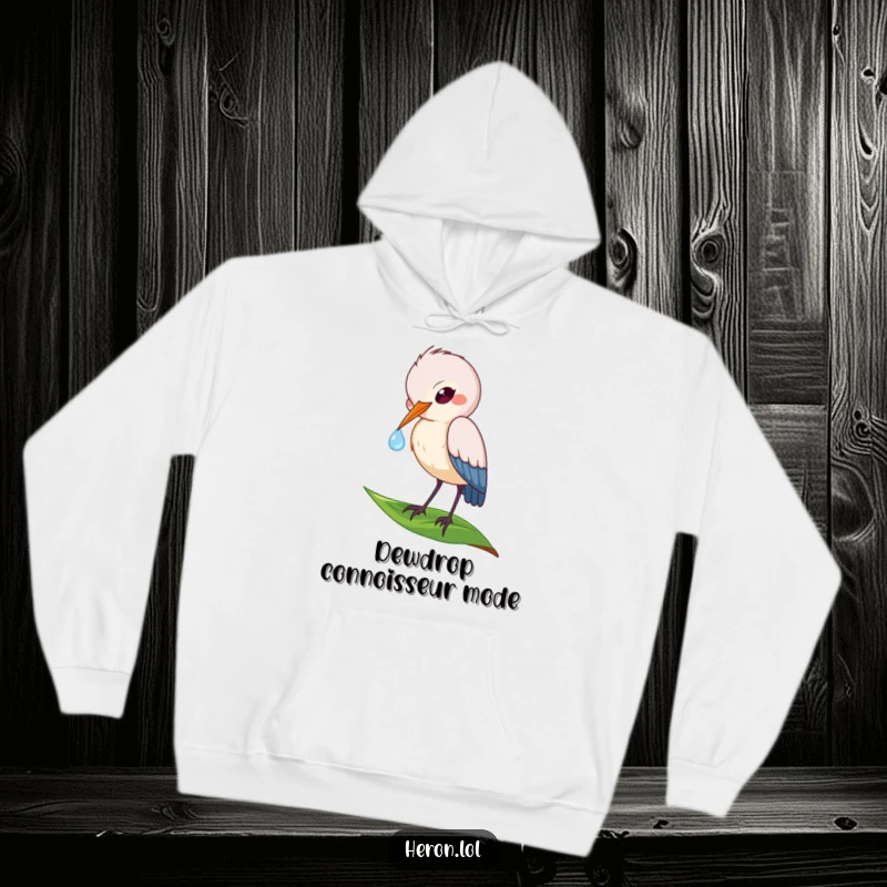 Funny hoodie featuring a playful heron bird delicately sipping a dewdrop from a leaf, combining comfort with natural beauty.