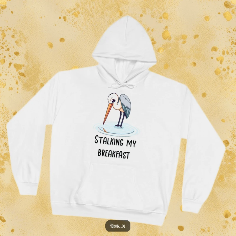 Heron bird with its long beak entering the water, captured on a soft and warm hoodie for nature lovers.