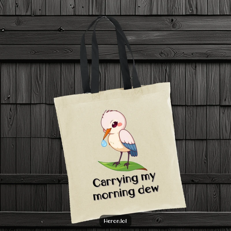 Funny tote bag decorated with a playful heron bird dipping its beak into a dewdrop on a leaf, perfect for nature lovers.